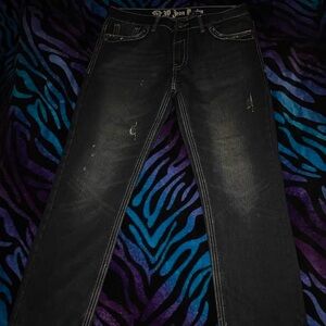 Black distressed denim jeans with a punk vibe